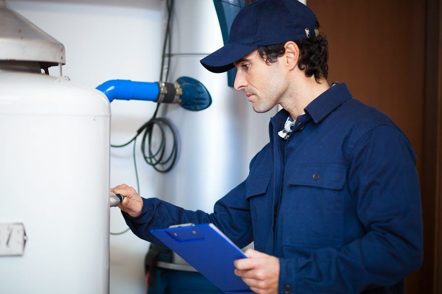 Technician inspecting water heater