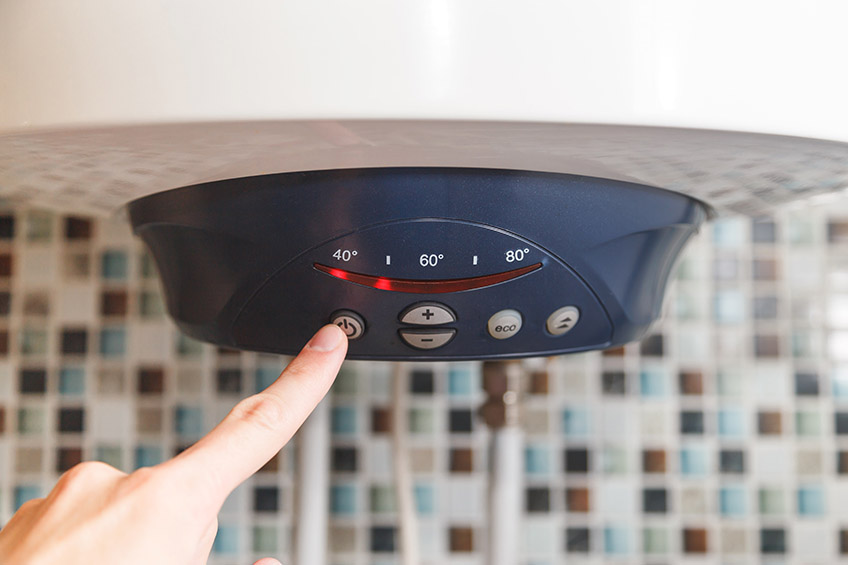 a person turning off the water heater