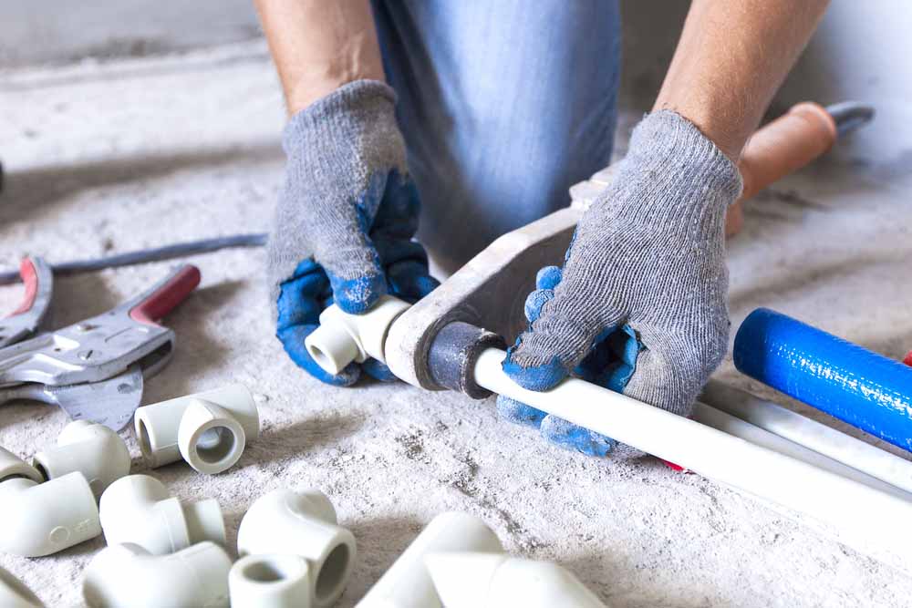 a plumber installing new pipes