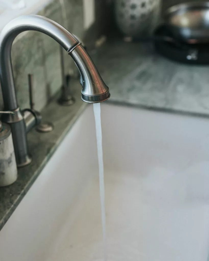 running water through a kitchen sink faucet