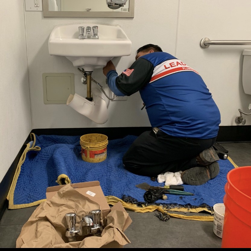 employee working on sink repair